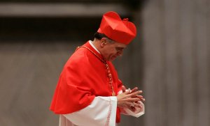 New cardinal Daniel N. DiNardo of the U.S. leaves the altar after he received the biretta from Pope Benedict XVI during the Consistory ceremony in Saint Peter's Basilica at the Vatican